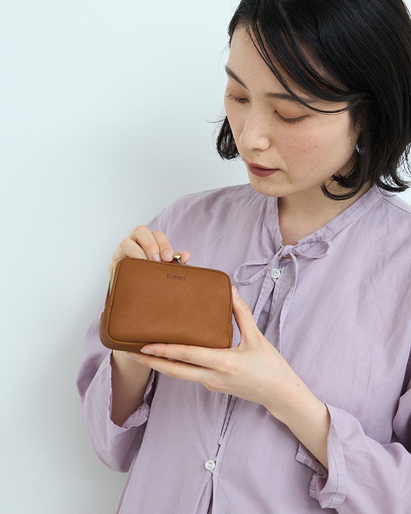 落ち着いたミルクチョコの革財布。ナチュラルで飽きのこない色合いが、毎日使えるがま口ミニ財布にぴったり